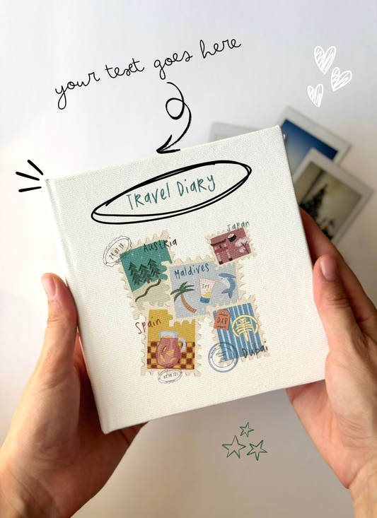 Travel diary with illustrated covers held by hands on a light background
